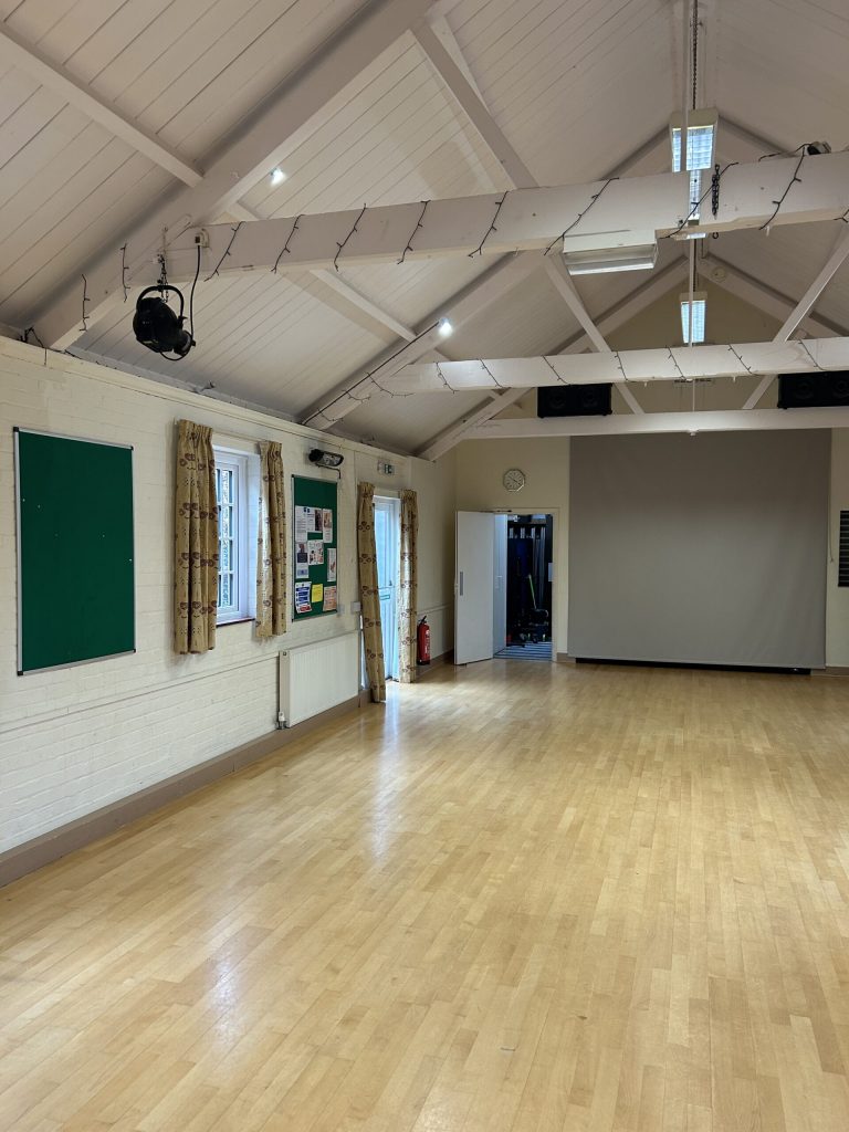 Small stage area which is used for storage of chairs.